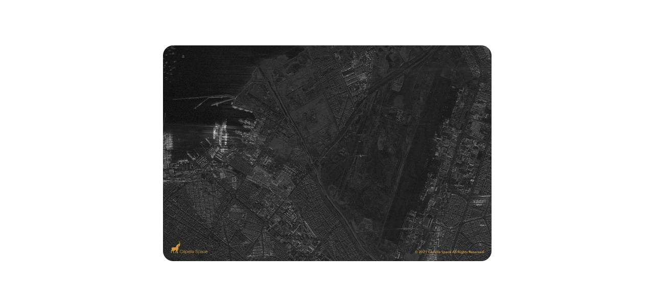 Dos personas que llevan ropa de invierno y equipo de seguridad naranja quitando la nieve acumulada a lo largo de una carretera transitada