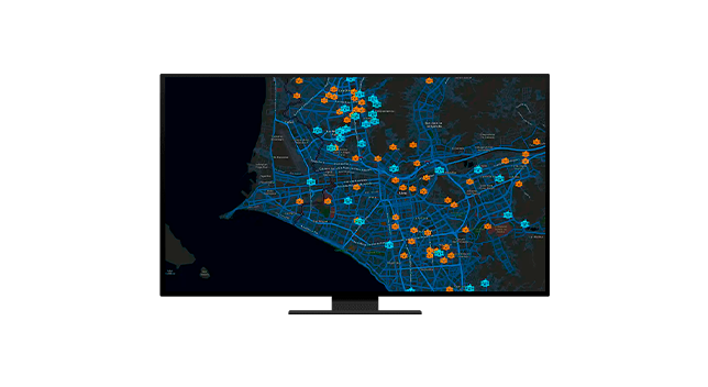 Dos personas que llevan ropa de invierno y equipo de seguridad naranja quitando la nieve acumulada a lo largo de una carretera transitada