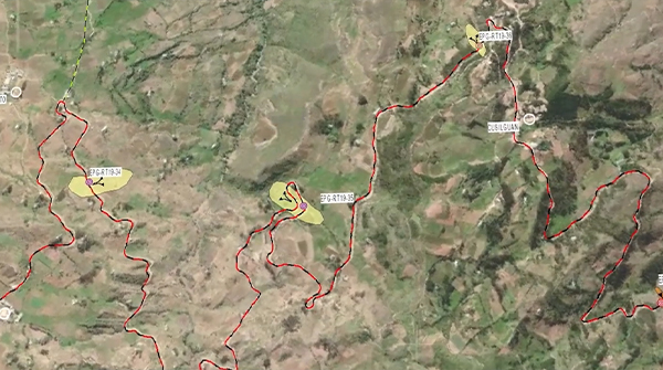 Real-time data visualization of transportation or movement patterns, with neon lines in purple, pink, and green spreading across a dark map, showing high-traffic pathways.