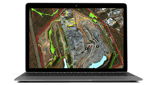 Un portátil que muestra un mapa de un área delineada en azul con marcas de calor y edificios en los alrededores delineados en rojo