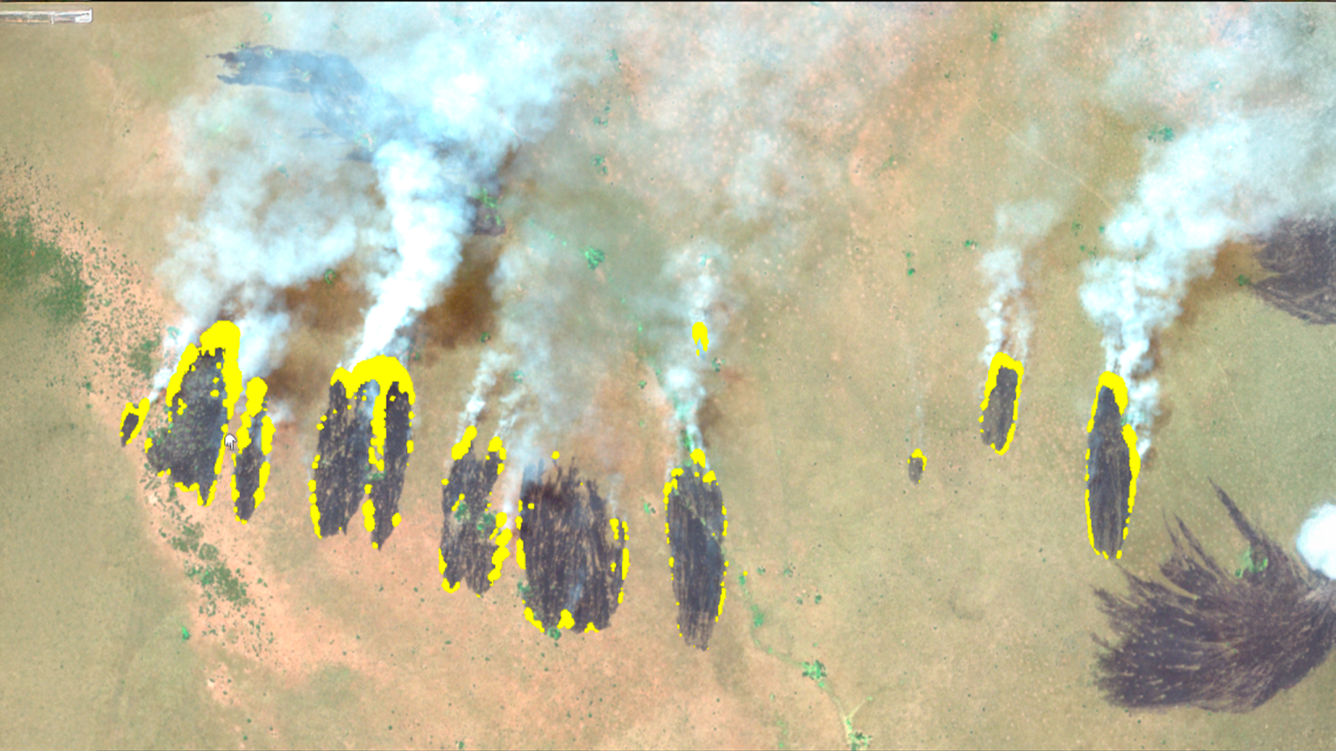 Three young adults smiling while backpacking through a field