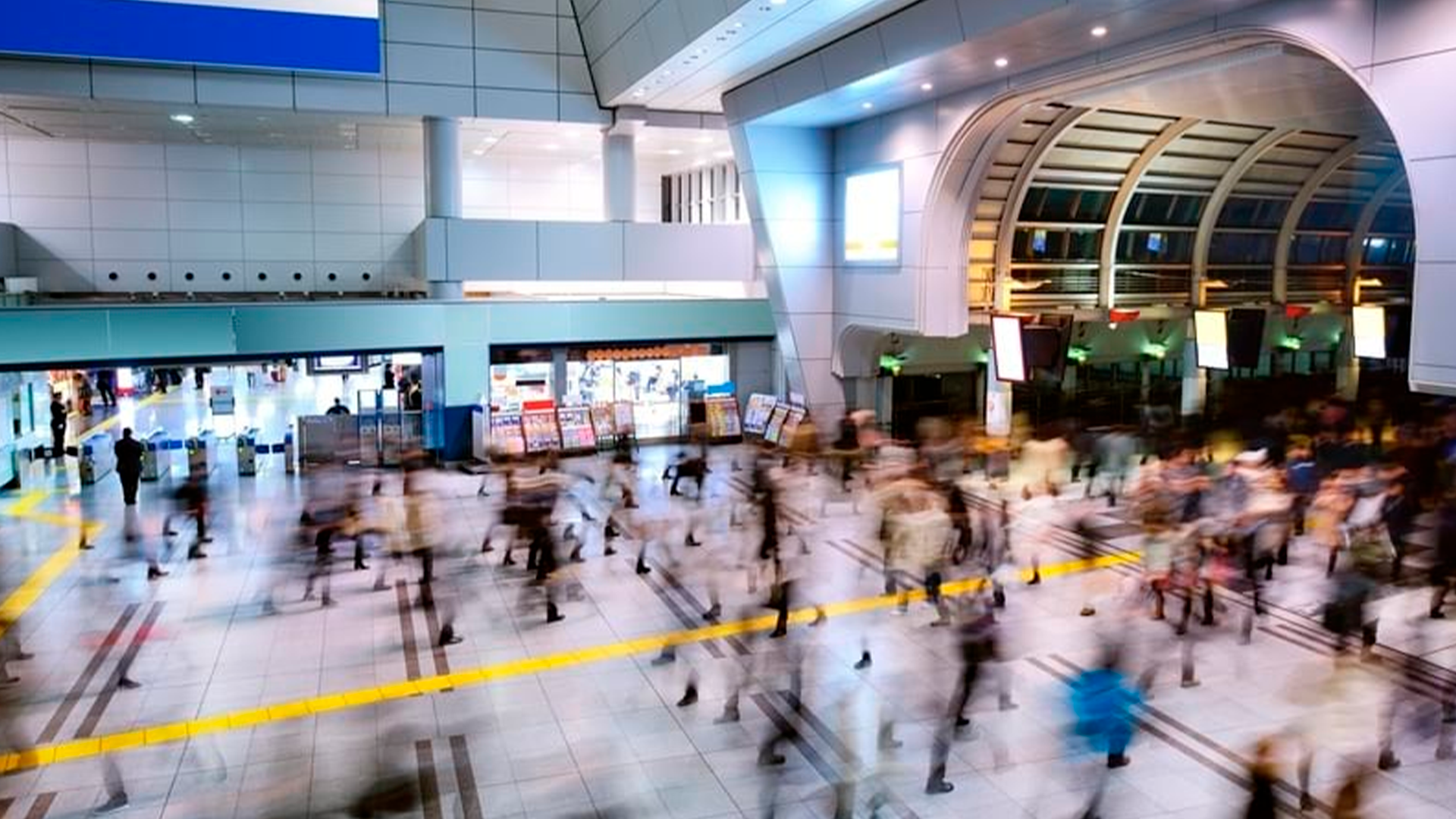Three young adults smiling while backpacking through a field