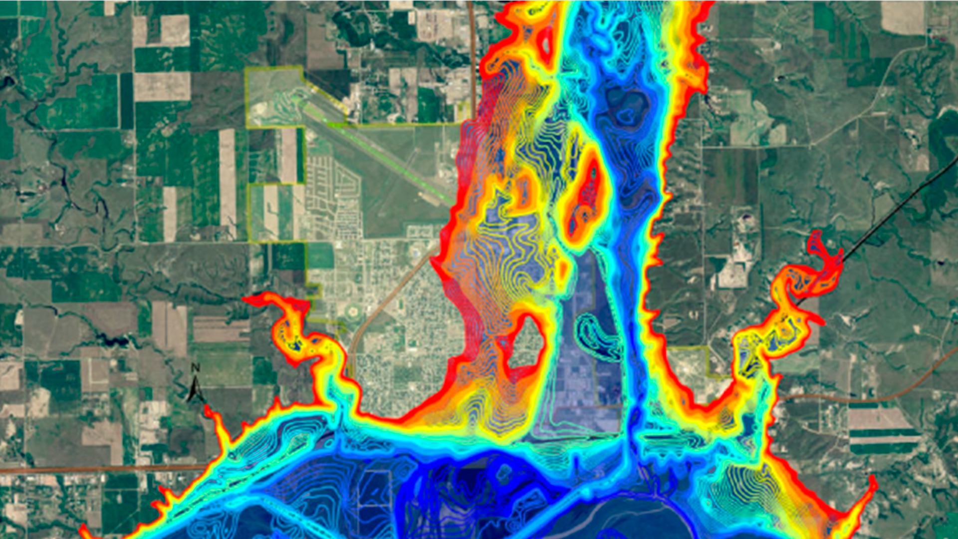 Three young adults smiling while backpacking through a field