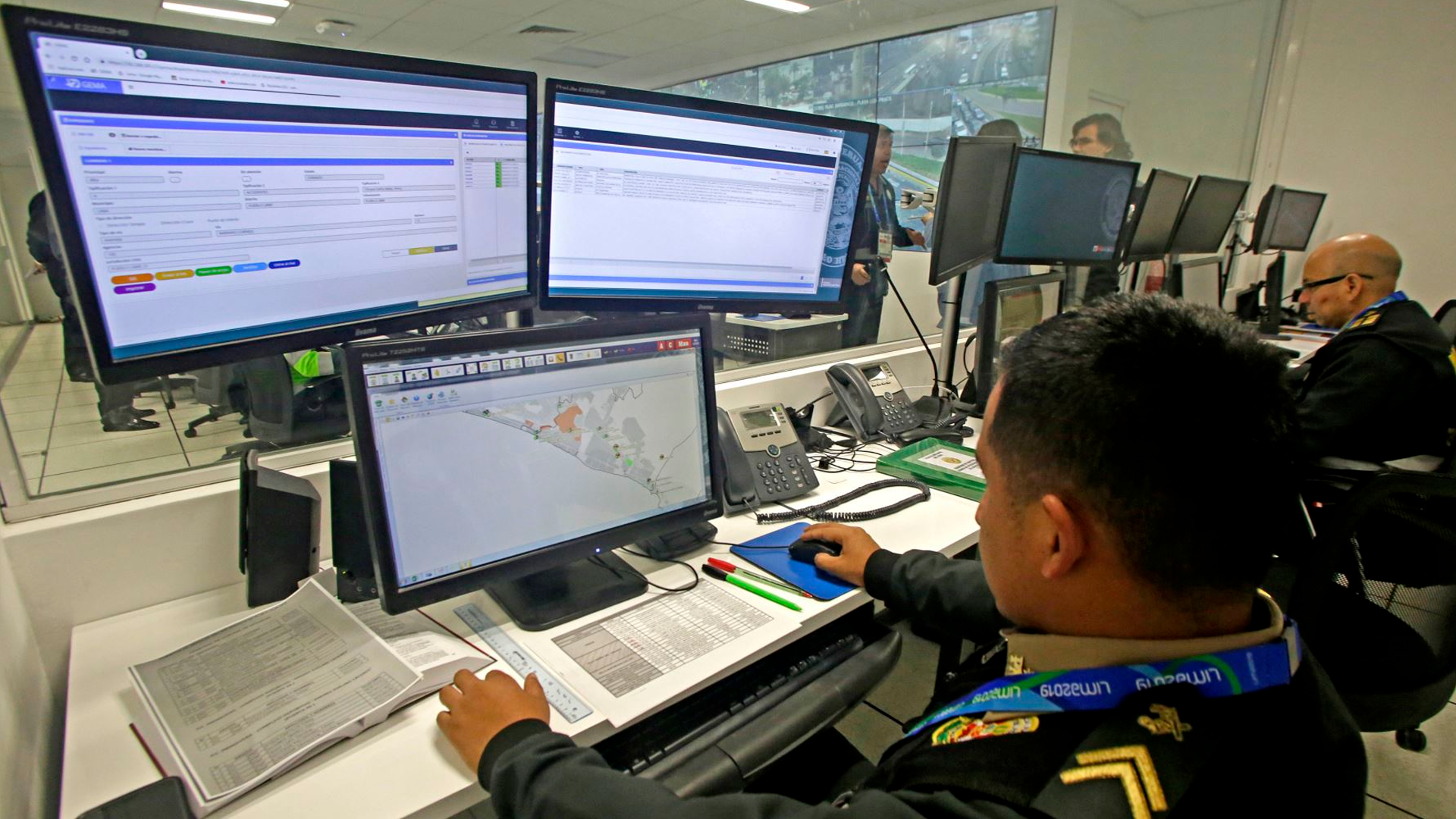 Three young adults smiling while backpacking through a field