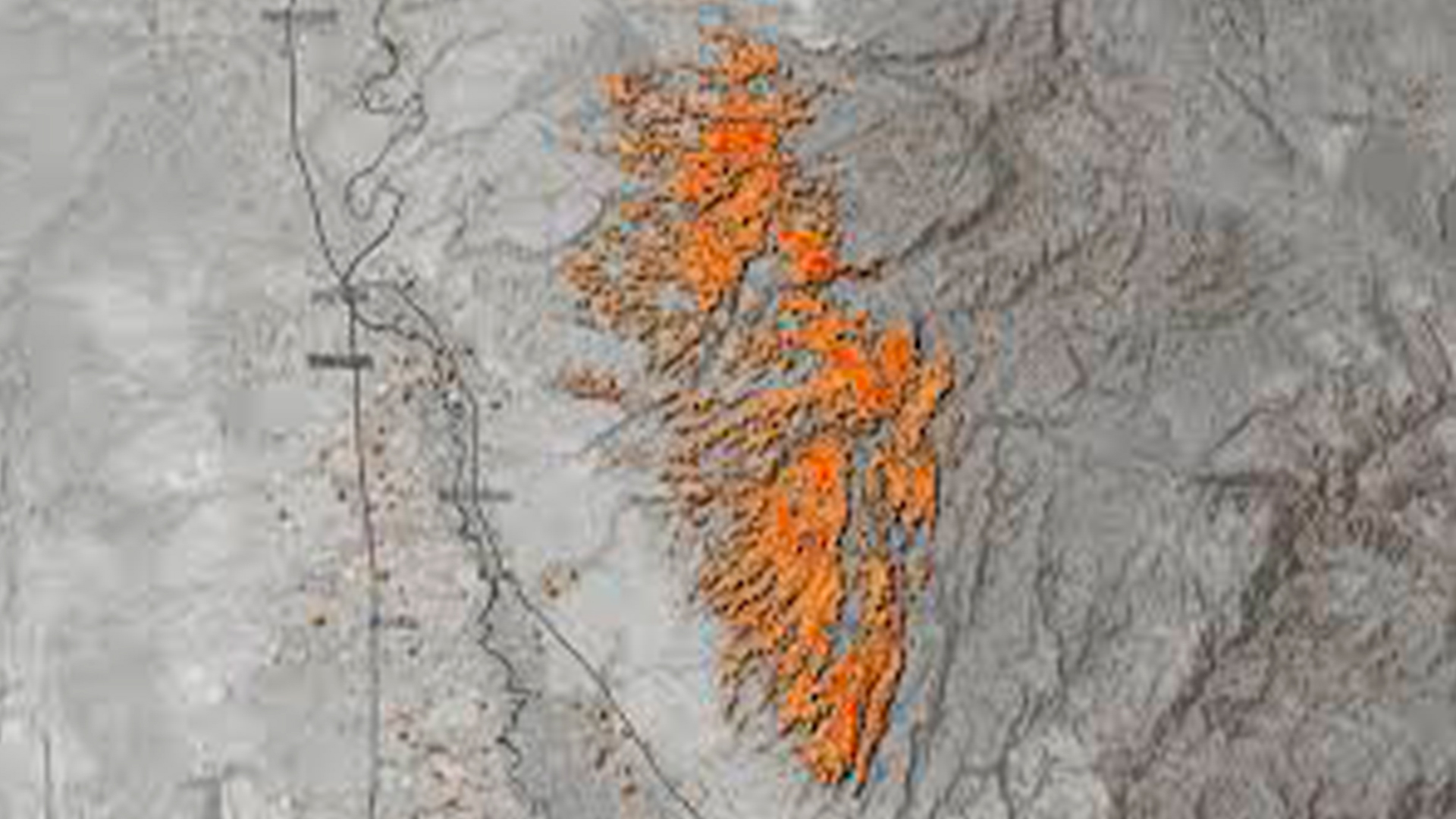 Three young adults smiling while backpacking through a field