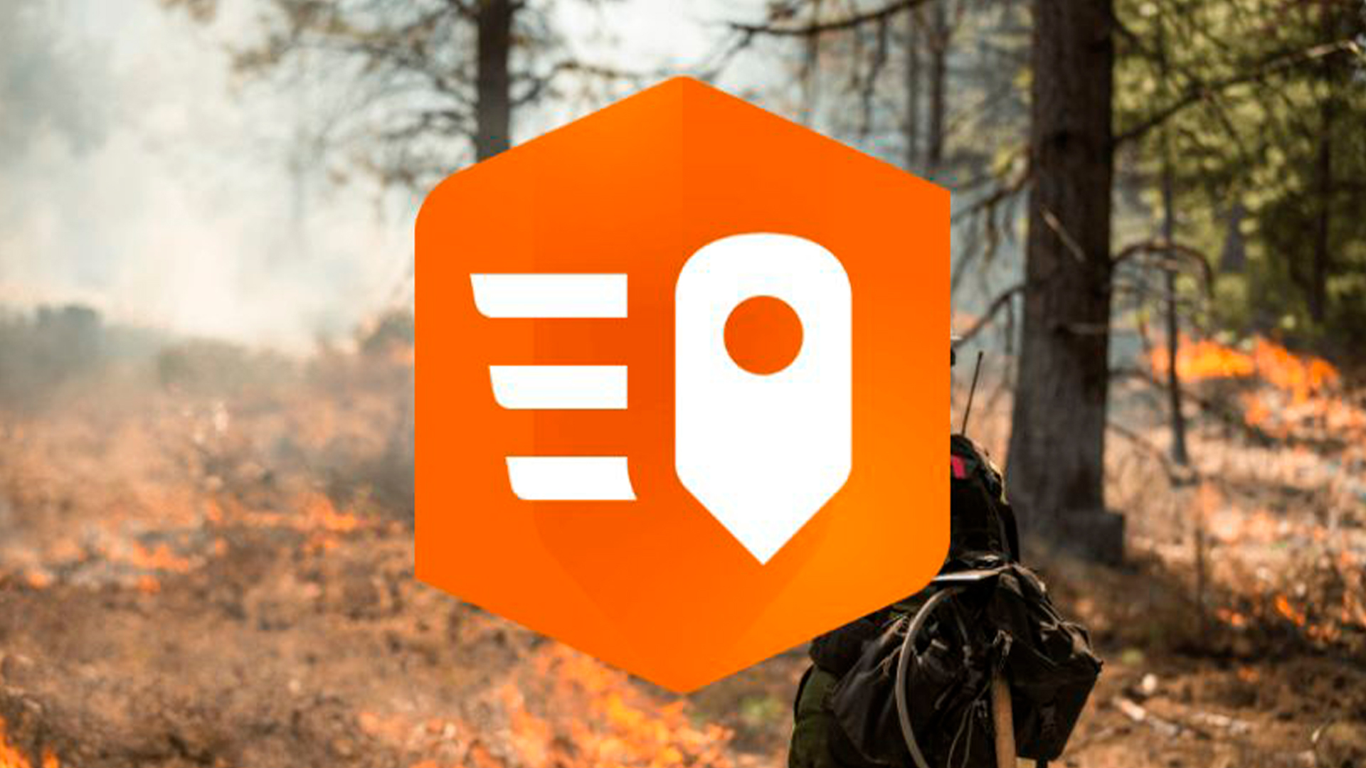 Three young adults smiling while backpacking through a field