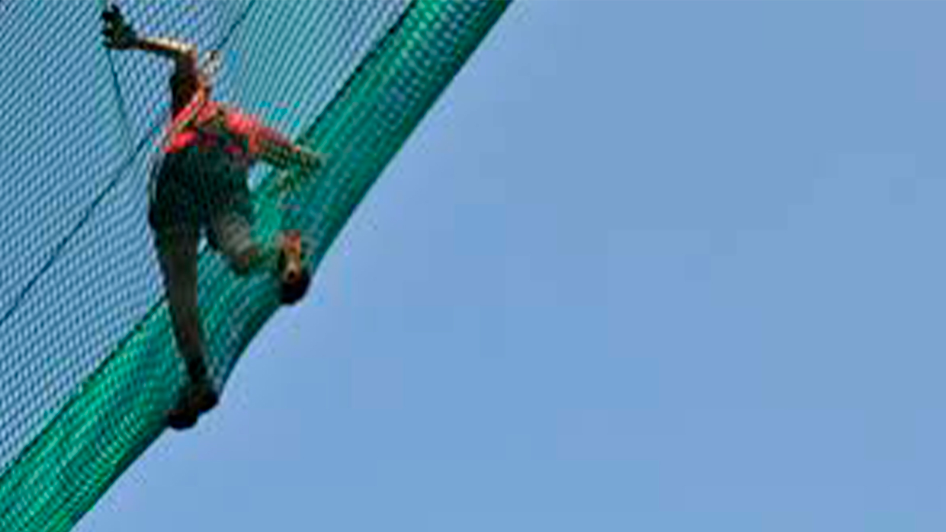 Three young adults smiling while backpacking through a field