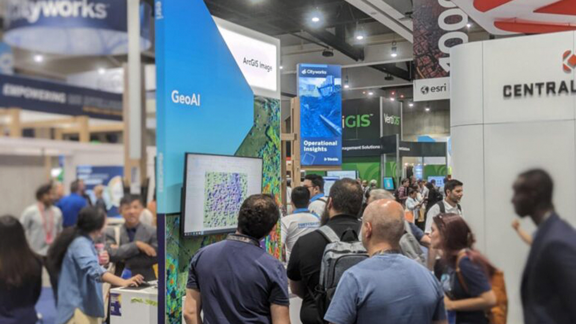 Three young adults smiling while backpacking through a field