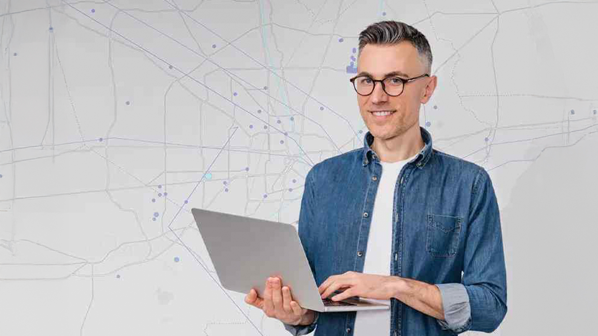 Three young adults smiling while backpacking through a field