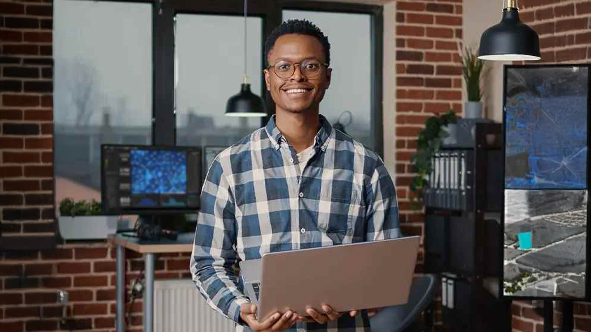 Three young adults smiling while backpacking through a field