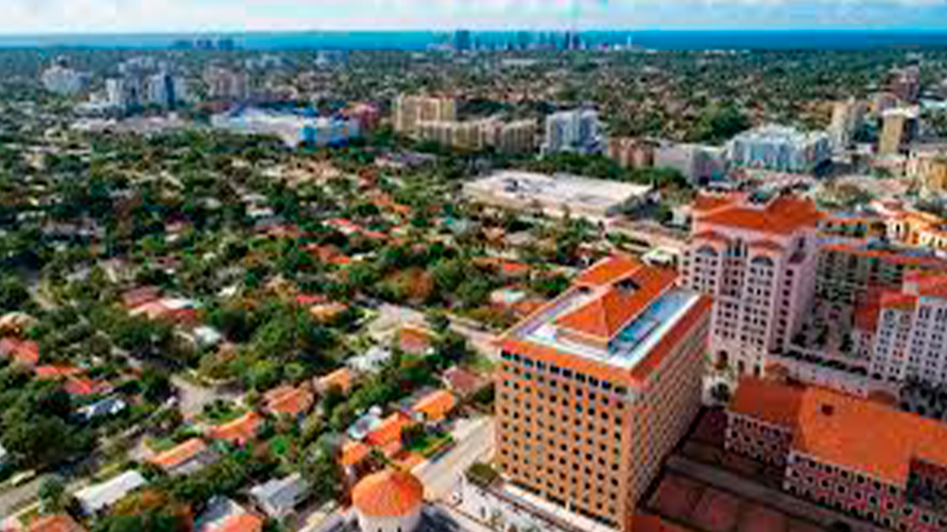 Three young adults smiling while backpacking through a field