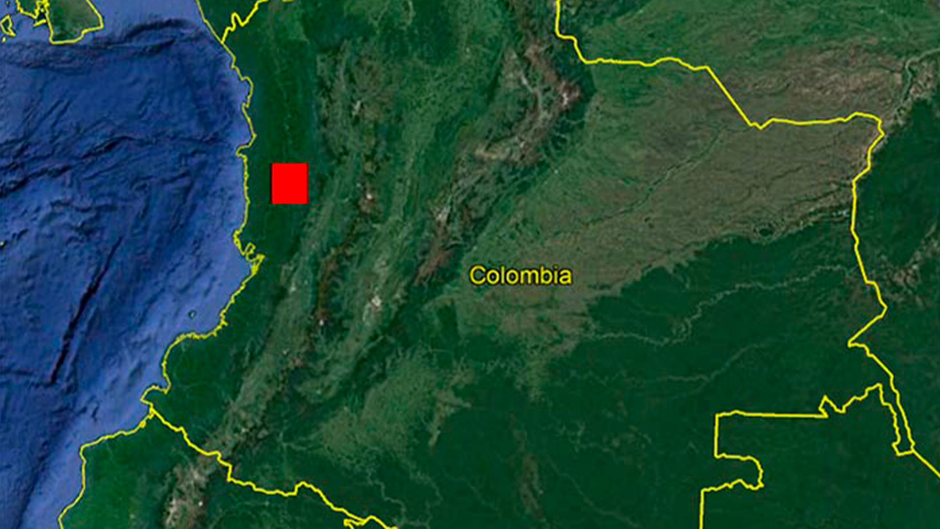 Three young adults smiling while backpacking through a field