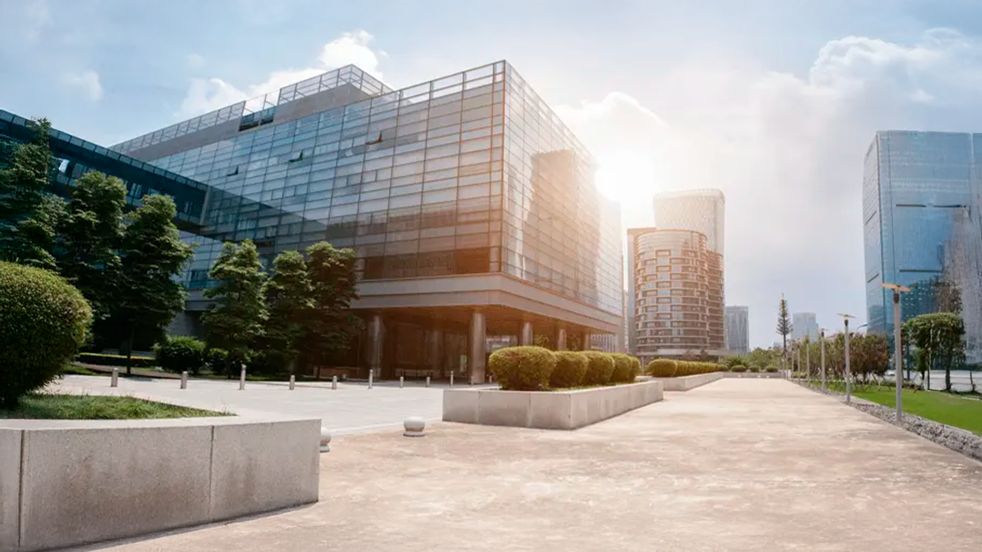 Three young adults smiling while backpacking through a field
