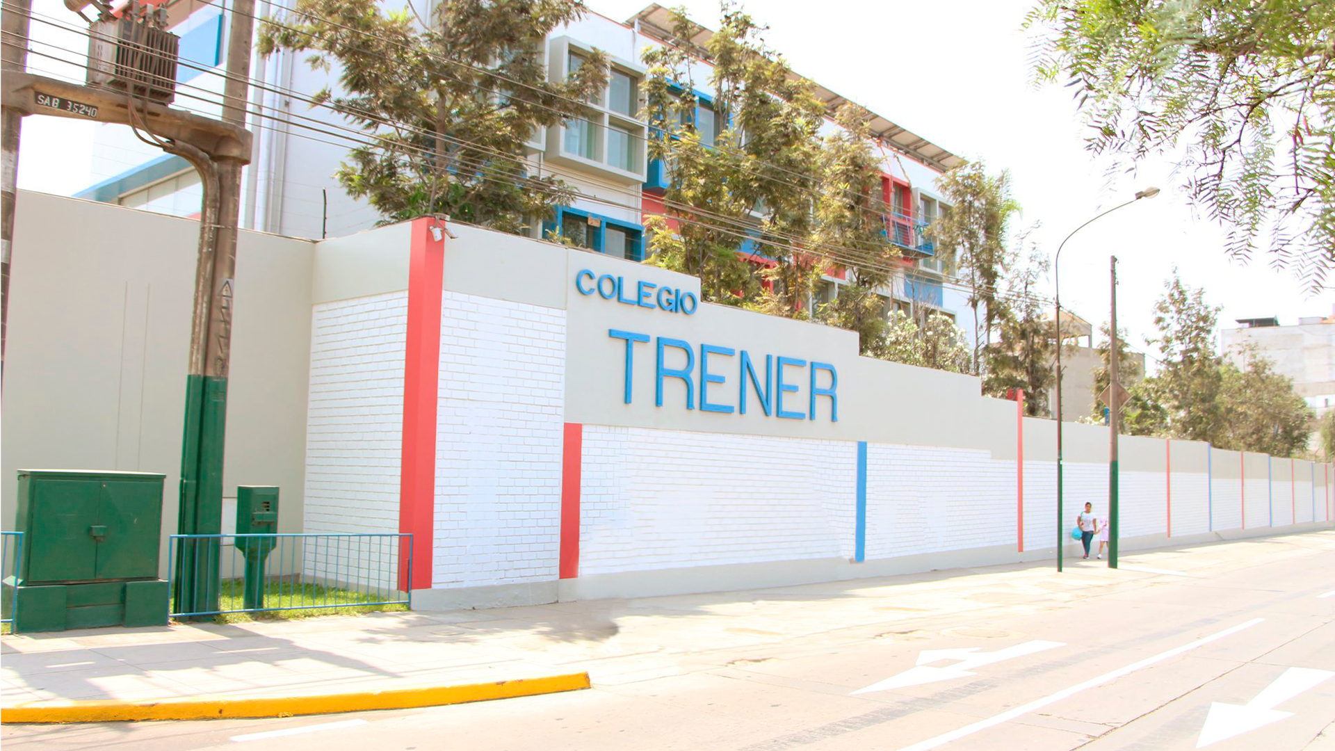 Three young adults smiling while backpacking through a field