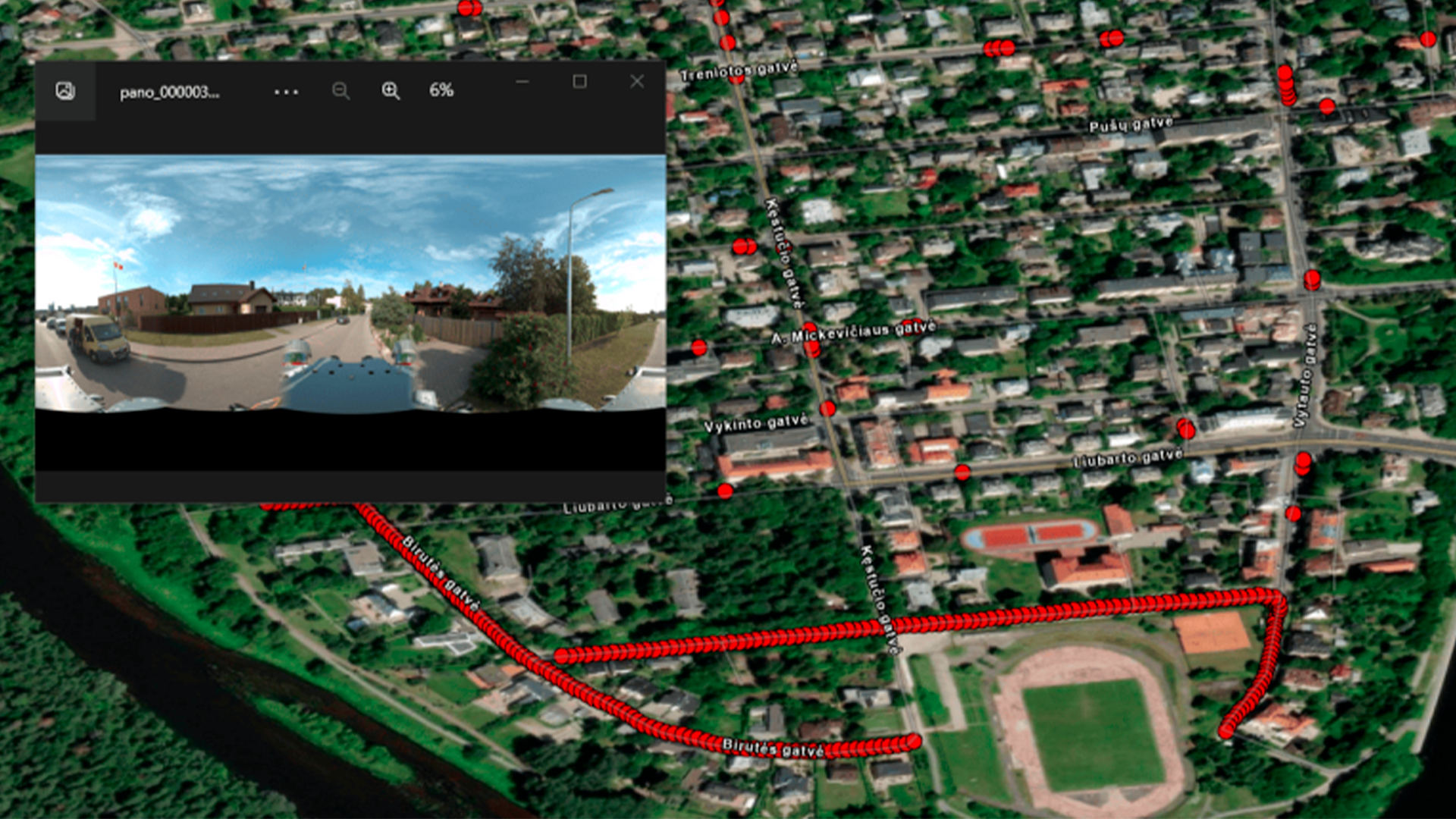 Three young adults smiling while backpacking through a field