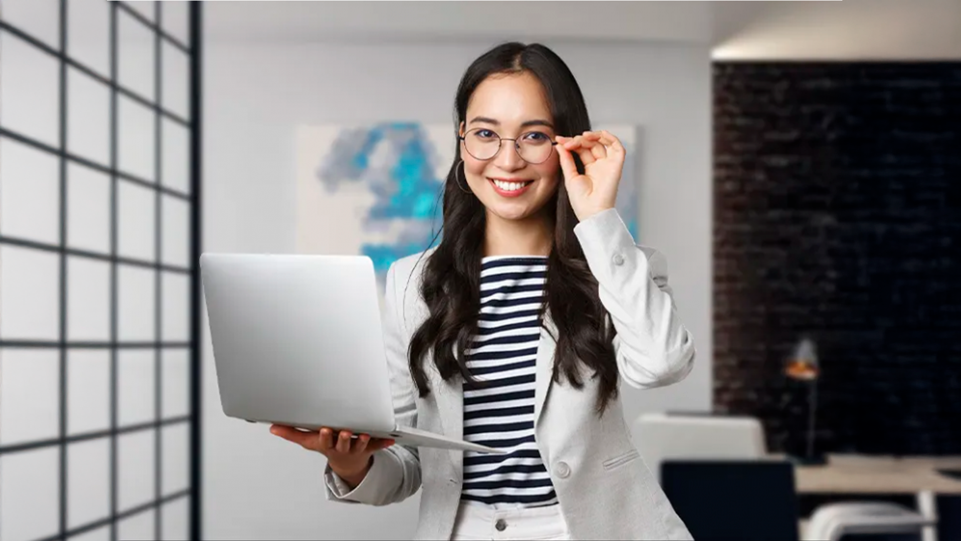 Three young adults smiling while backpacking through a field