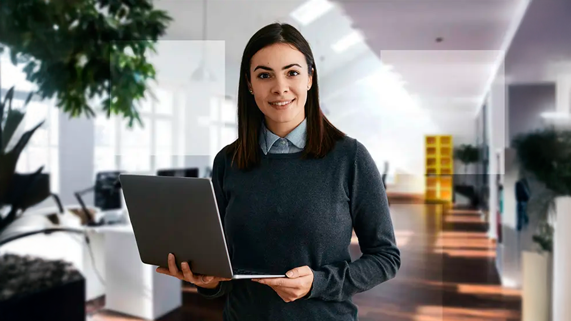 Three young adults smiling while backpacking through a field