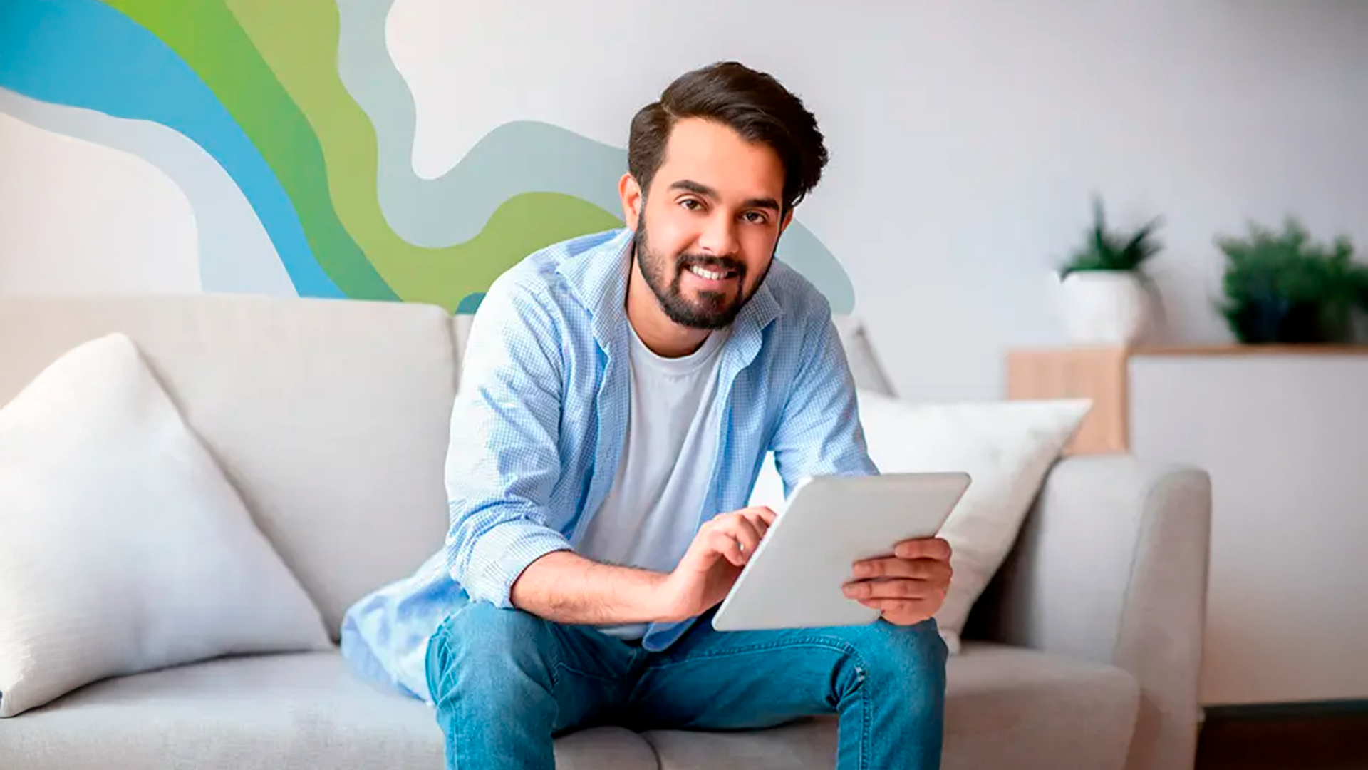 Three young adults smiling while backpacking through a field