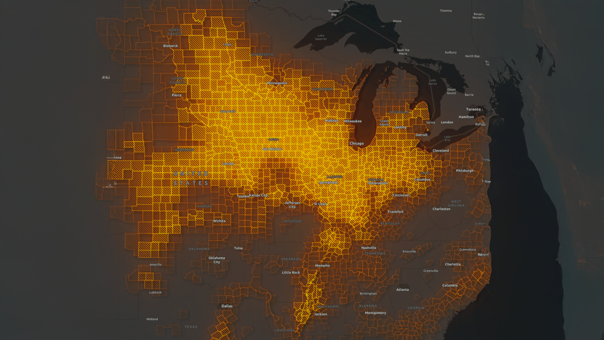 Three young adults smiling while backpacking through a field