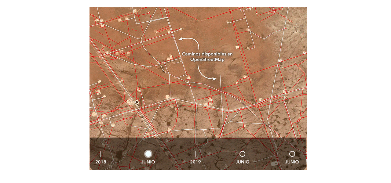 Dos personas que llevan ropa de invierno y equipo de seguridad naranja quitando la nieve acumulada a lo largo de una carretera transitada