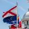 Image of the Alabama Capitol building with flags flying on a sunny day