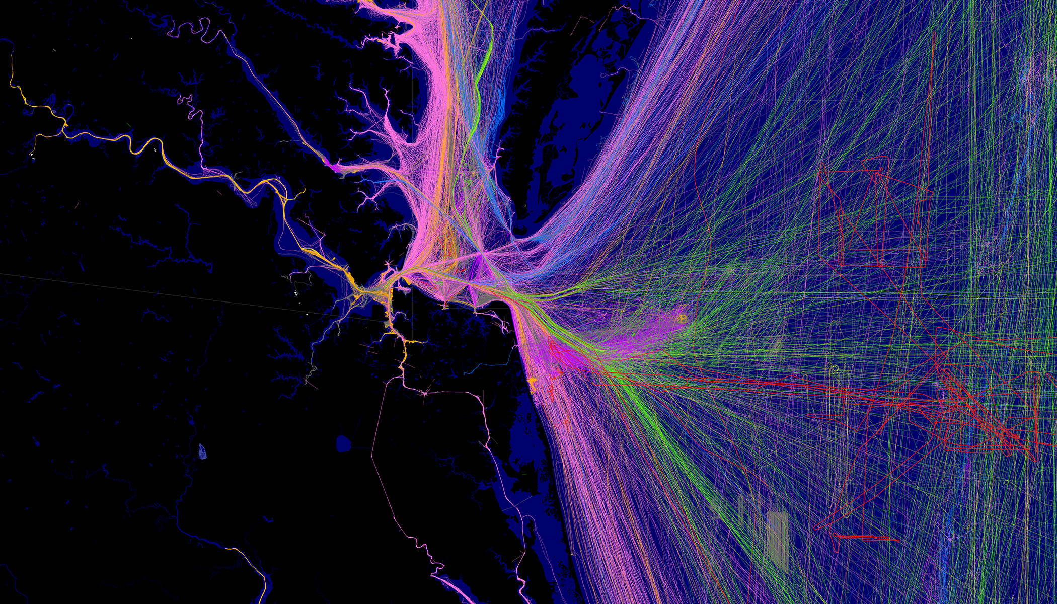 Visualización de datos en tiempo real de patrones de transporte o movimiento, con líneas de neón en morado, rosa y verde que se extienden por un mapa oscuro, mostrando las vías de alto tráfico.