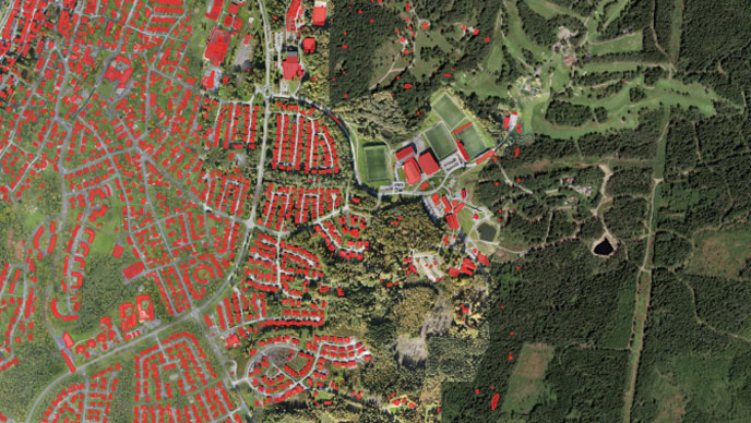 Una imagen aérea de una ciudad con edificios extraídos en terreno rojo y verde