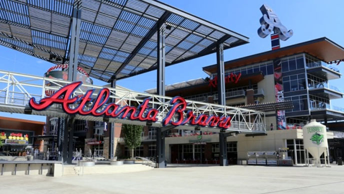 Exterior de un estadio de béisbol con un gran cartel rojo de los Atlanta Braves