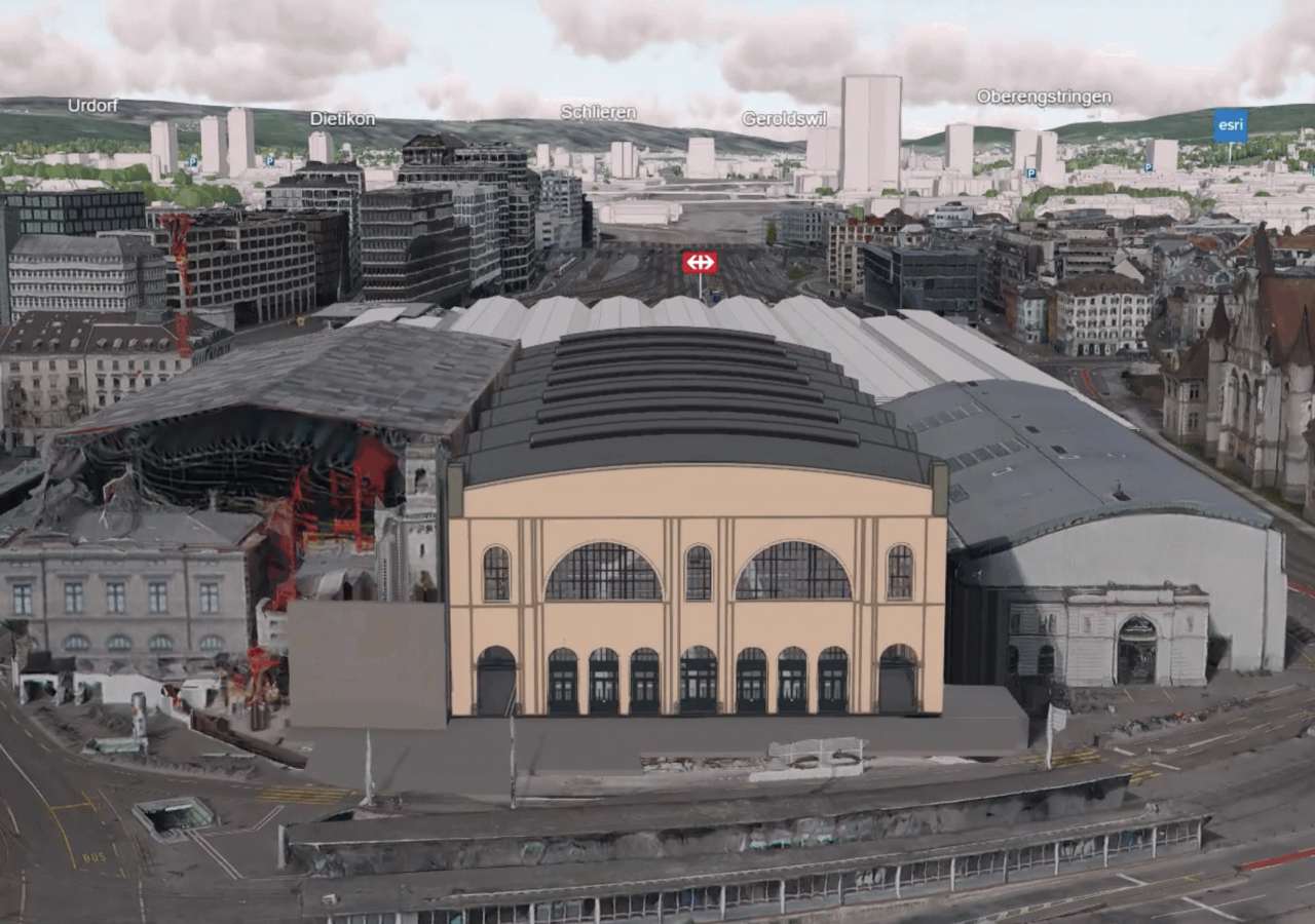 Vista 3D de edificios modelados para la construcción con nombres etiquetados, incluidos Esri y Urdorf, en la distancia